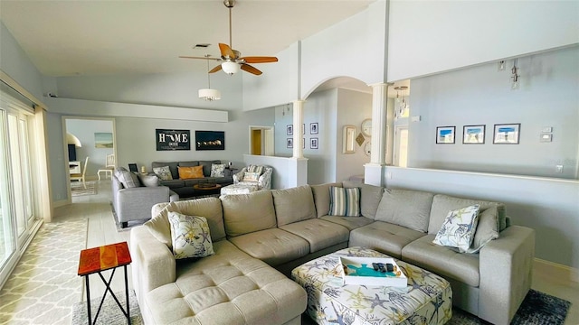 2399 Bendway Dr, Port Charlotte, FL 33948 - living room featuring ornate columns, a ceiling fan, high vaulted ceiling, plenty of natural light, and baseboards
