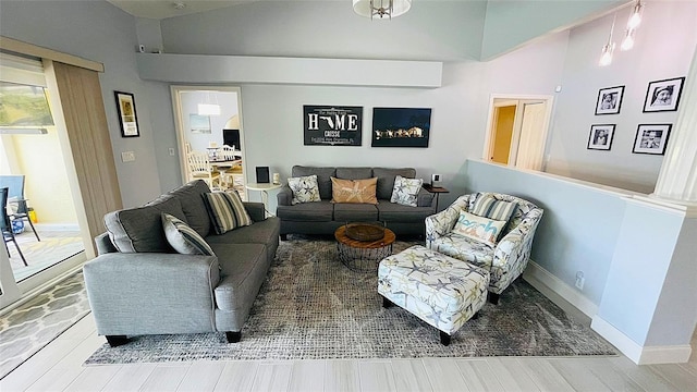 2399 Bendway Dr, Port Charlotte, FL 33948 - living room with wood finished floors, lofted ceiling, and baseboards