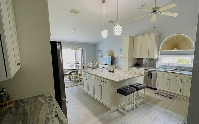 2399 Bendway Dr, Port Charlotte, FL 33948 - kitchen featuring stainless steel appliances, a sink, tasteful backsplash, ceiling fan, and hanging light fixtures