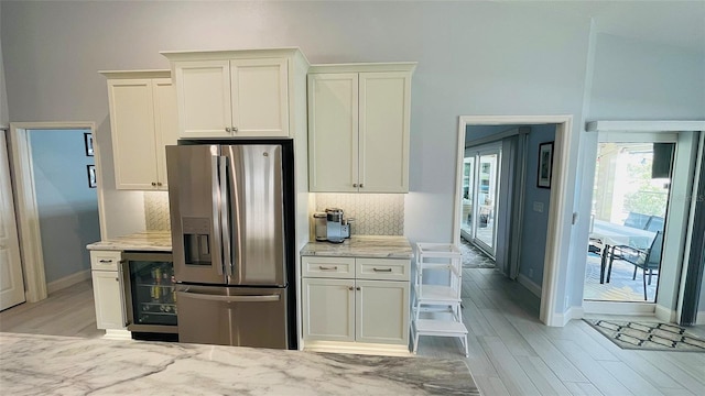 2399 Bendway Dr, Port Charlotte, FL 33948 - kitchen featuring stainless steel refrigerator with ice dispenser, light wood-style floors, tasteful backsplash, beverage cooler, and baseboards