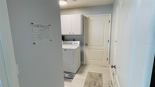 2399 Bendway Dr, Port Charlotte, FL 33948 - washroom with washer / dryer, cabinet space, and light wood-style floors