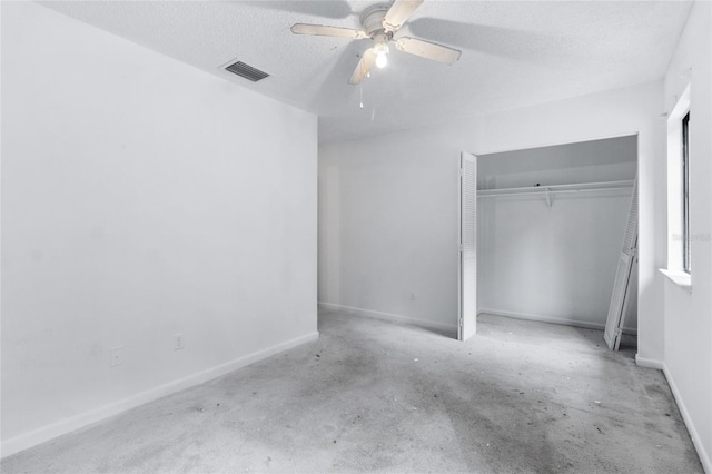 1515 Paul Russell Rd # 64, Tallahassee, FL 32301 - unfurnished bedroom featuring a closet, concrete flooring, a textured ceiling, baseboards, and a ceiling fan