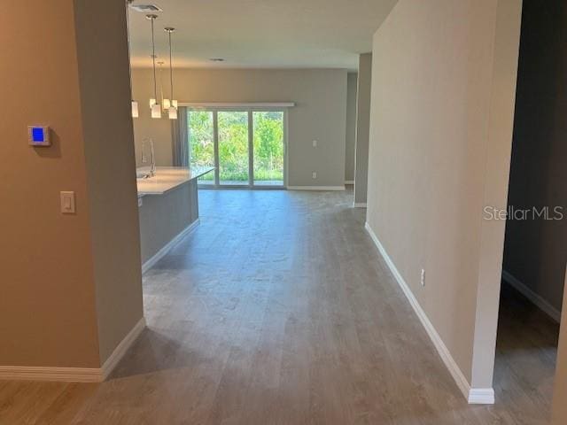 207 Baytree Dr, Rotonda West, FL 33947 - hallway featuring wood finished floors and baseboards