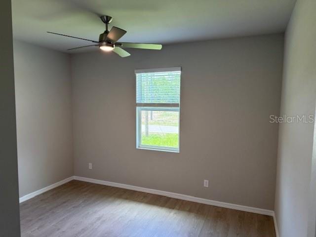 207 Baytree Dr, Rotonda West, FL 33947 - unfurnished room with wood finished floors, baseboards, and ceiling fan