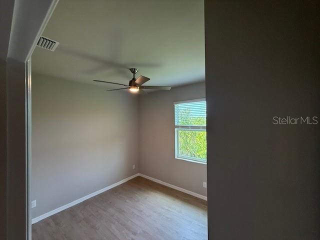 207 Baytree Dr, Rotonda West, FL 33947 - unfurnished room featuring baseboards, wood finished floors, and a ceiling fan