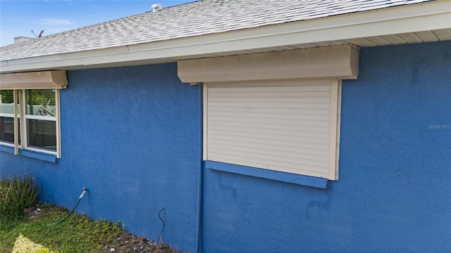 10229 Gulfstream Blvd, Englewood, FL 34224 - view of side of property featuring roof with shingles and stucco siding