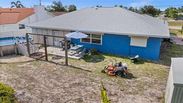 10229 Gulfstream Blvd, Englewood, FL 34224 - back of house featuring a patio, stucco siding, and a shingled roof