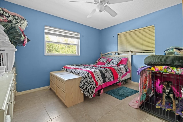 10229 Gulfstream Blvd, Englewood, FL 34224 - bedroom with light tile patterned floors, ceiling fan, and baseboards