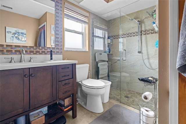 10229 Gulfstream Blvd, Englewood, FL 34224 - full bath with toilet, a stall shower, vanity, tile patterned flooring, and tasteful backsplash