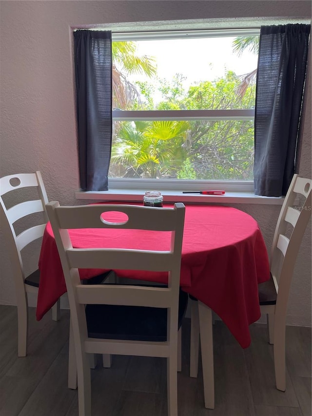 5727 Beechwood St, Punta Gorda, FL 33982 - dining area featuring plenty of natural light, wood finished floors, and a textured wall