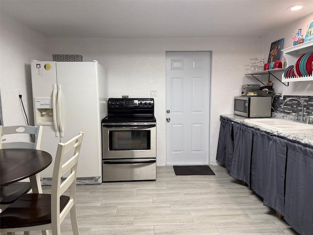 5727 Beechwood St, Punta Gorda, FL 33982 - kitchen with appliances with stainless steel finishes, a sink, light countertops, and wood finish floors
