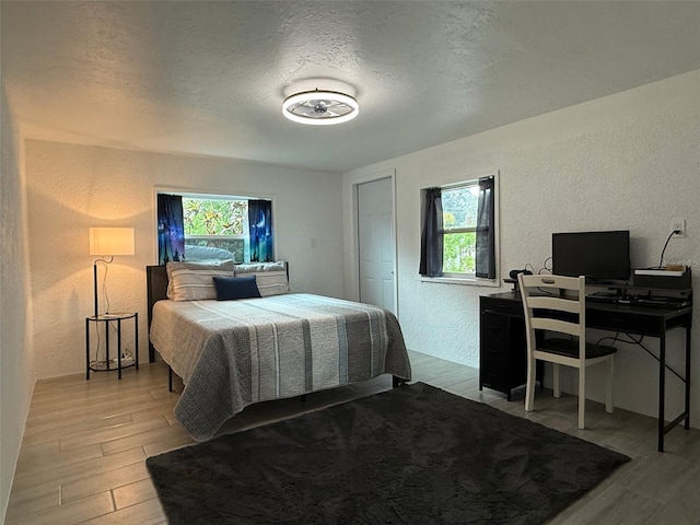 5727 Beechwood St, Punta Gorda, FL 33982 - bedroom with a textured wall, wood finished floors, a textured ceiling, and a desk