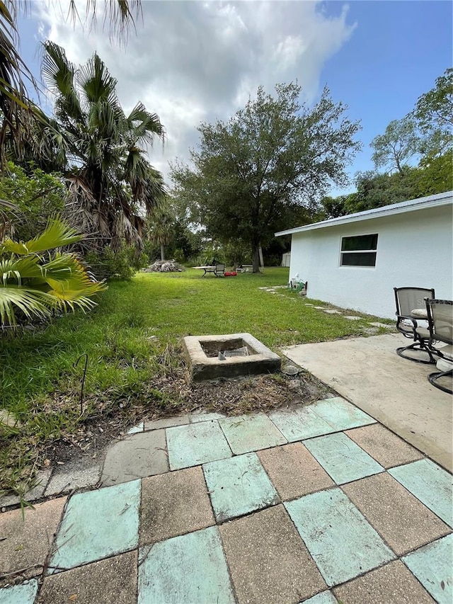 5727 Beechwood St, Punta Gorda, FL 33982 - view of grassy yard with a patio area and a fire pit