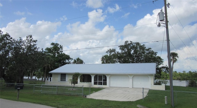 9986 SW Riverview Cir, Arcadia, FL 34269 - ranch-style home featuring driveway, a garage, stucco siding, and a metal roof