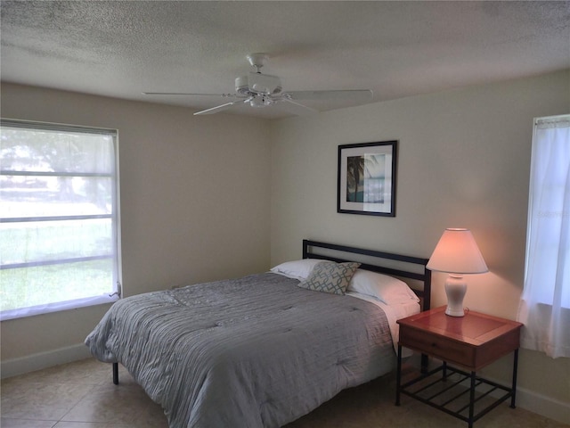 9986 SW Riverview Cir, Arcadia, FL 34269 - tiled bedroom featuring multiple windows, a textured ceiling, and ceiling fan