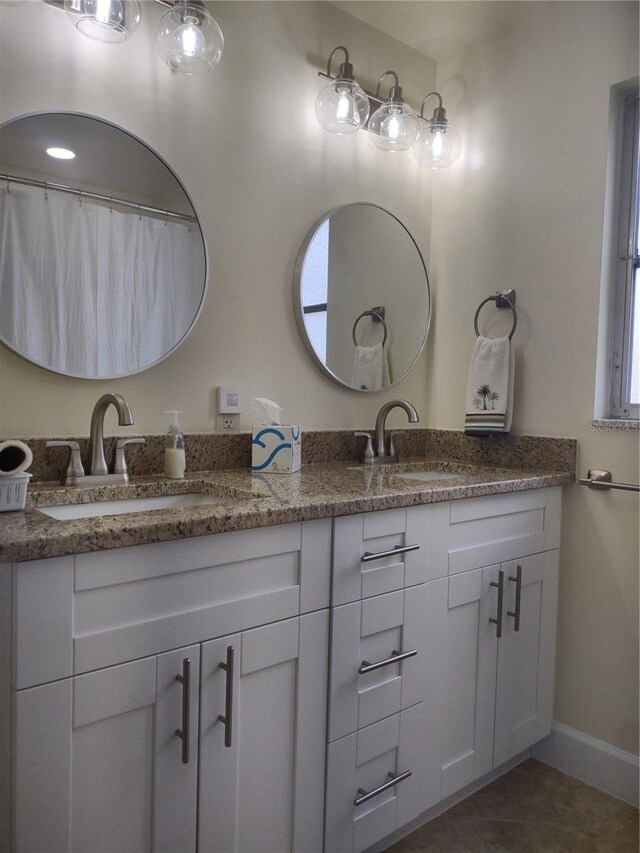 9986 SW Riverview Cir, Arcadia, FL 34269 - bathroom with double vanity and tile patterned floors