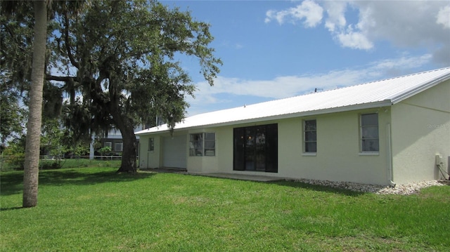 9986 SW Riverview Cir, Arcadia, FL 34269 - back of property featuring stucco siding and a metal roof