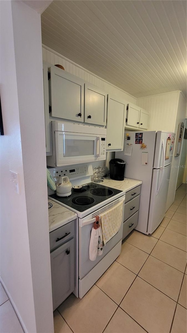 13366 Ballon Ave, Port Charlotte, FL 33981 - kitchen featuring white appliances, gray cabinetry, light tile patterned floors, and wooden ceiling