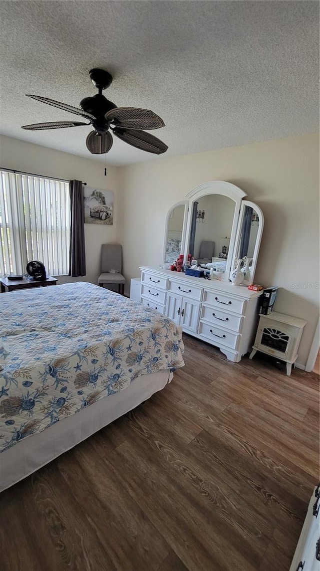 13366 Ballon Ave, Port Charlotte, FL 33981 - bedroom featuring a textured ceiling, dark wood-style floors, ceiling fan, and arched walkways