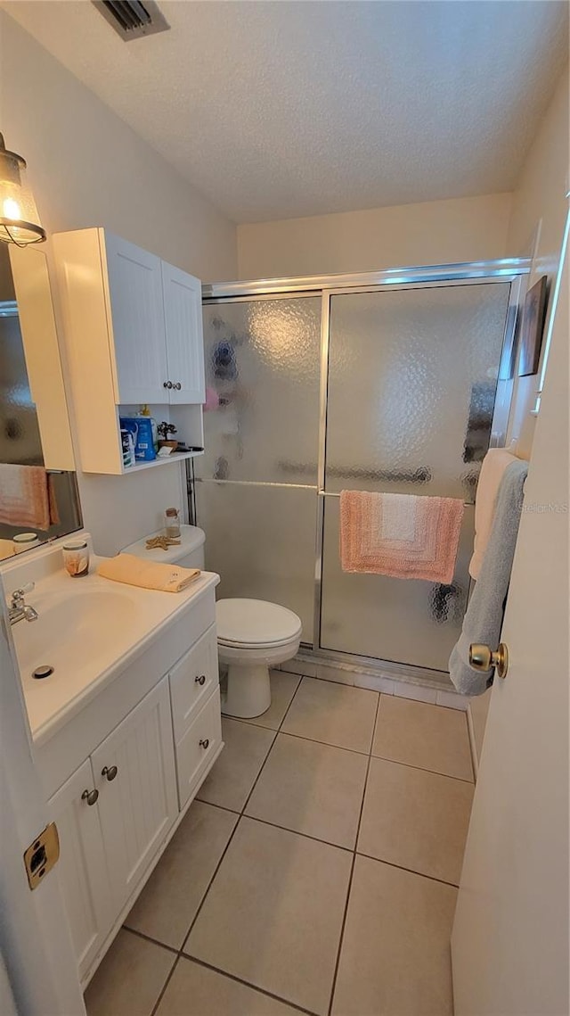 13366 Ballon Ave, Port Charlotte, FL 33981 - bathroom with vanity, a stall shower, tile patterned floors, and toilet