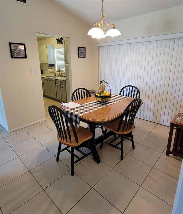 13366 Ballon Ave, Port Charlotte, FL 33981 - dining space with light tile patterned floors, lofted ceiling, and a chandelier