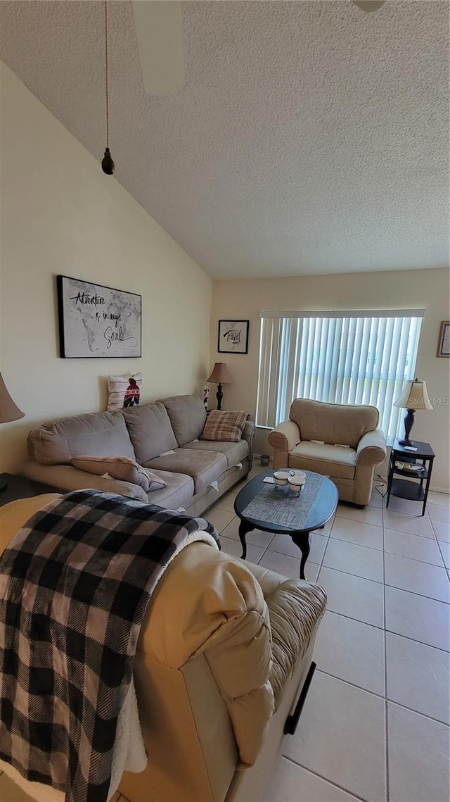 13366 Ballon Ave, Port Charlotte, FL 33981 - living area with a textured ceiling, light tile patterned flooring, and vaulted ceiling