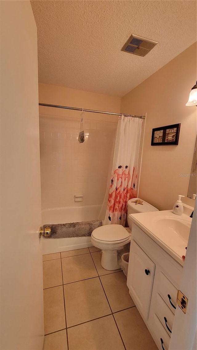 13366 Ballon Ave, Port Charlotte, FL 33981 - bathroom with vanity, tile patterned flooring, toilet, a textured ceiling, and shower / bath combo