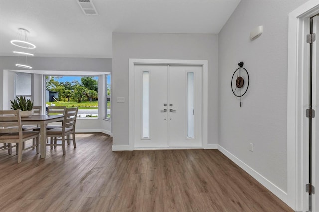 229 Waterside St, Port Charlotte, FL 33954 - foyer entrance with baseboards and wood finished floors