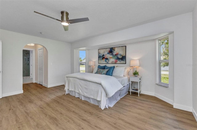 229 Waterside St, Port Charlotte, FL 33954 - bedroom featuring multiple windows, wood finished floors, arched walkways, and ceiling fan