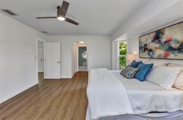 229 Waterside St, Port Charlotte, FL 33954 - bedroom with arched walkways, wood finished floors, and a ceiling fan