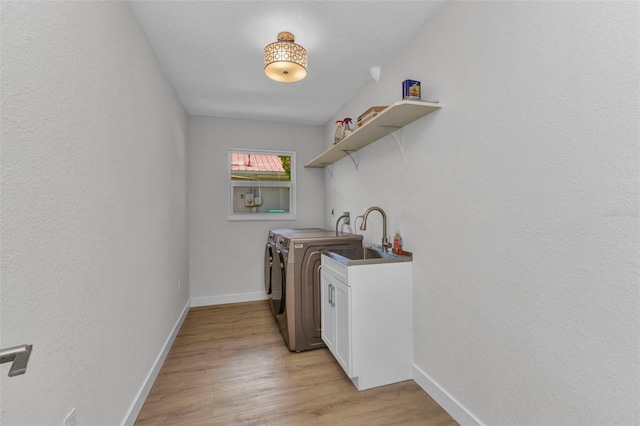 229 Waterside St, Port Charlotte, FL 33954 - washroom with washing machine and clothes dryer, light wood-style floors, and cabinet space