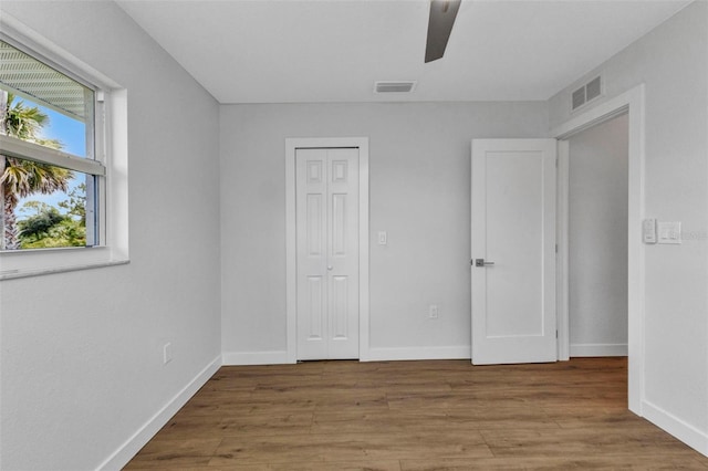 229 Waterside St, Port Charlotte, FL 33954 - unfurnished bedroom featuring wood finished floors, a closet, and ceiling fan