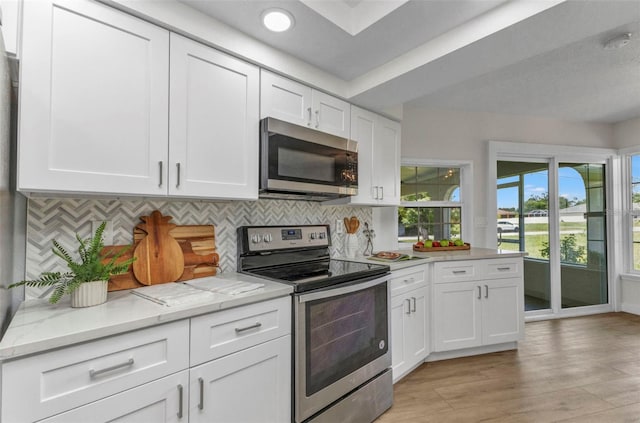 229 Waterside St, Port Charlotte, FL 33954 - kitchen with appliances with stainless steel finishes, white cabinets, tasteful backsplash, and recessed lighting