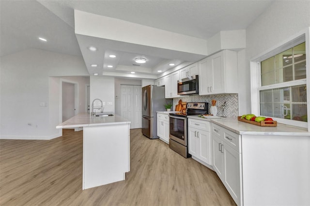 229 Waterside St, Port Charlotte, FL 33954 - kitchen with appliances with stainless steel finishes, light wood-type flooring, white cabinetry, backsplash, and recessed lighting