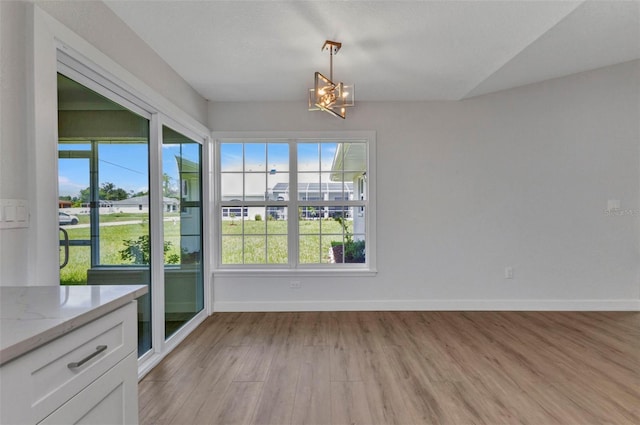 229 Waterside St, Port Charlotte, FL 33954 - unfurnished dining area with a chandelier and light wood-style flooring