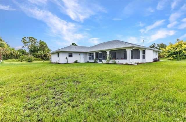 229 Waterside St, Port Charlotte, FL 33954 - back of property featuring a lawn and stucco siding