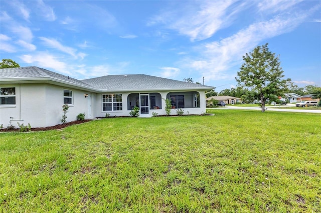 229 Waterside St, Port Charlotte, FL 33954 - back of house with a lawn, stucco siding, roof with shingles, and a sunroom