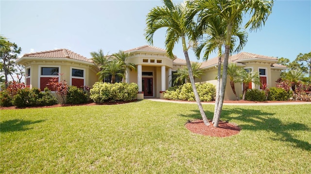 6057 Calusa Ridge Trl, Bokeelia, FL 33922 - mediterranean / spanish home featuring a front yard, stucco siding, and a tile roof