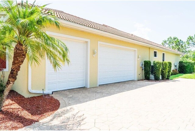 6057 Calusa Ridge Trl, Bokeelia, FL 33922 - garage featuring driveway