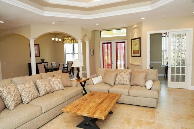 6057 Calusa Ridge Trl, Bokeelia, FL 33922 - living room with ornate columns, ornamental molding, recessed lighting, arched walkways, and a chandelier