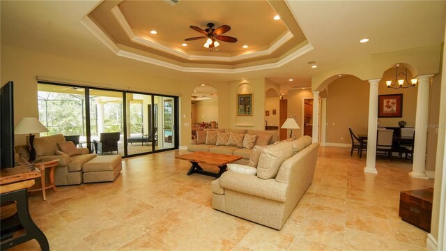 6057 Calusa Ridge Trl, Bokeelia, FL 33922 - living area with ornate columns, a ceiling fan, a raised ceiling, crown molding, and recessed lighting