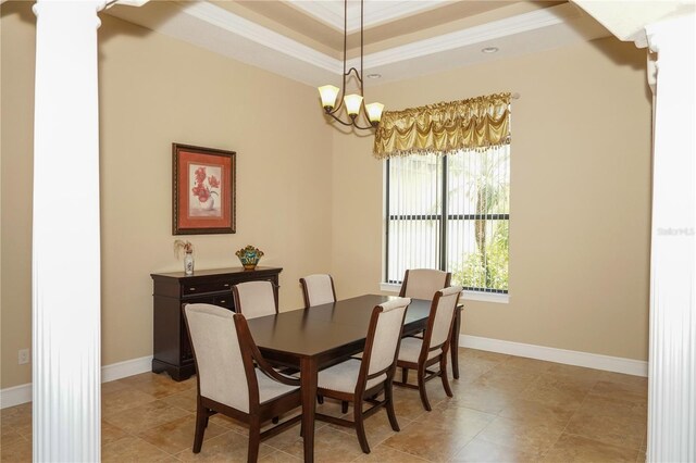 6057 Calusa Ridge Trl, Bokeelia, FL 33922 - dining area with crown molding, a chandelier, a tray ceiling, and baseboards