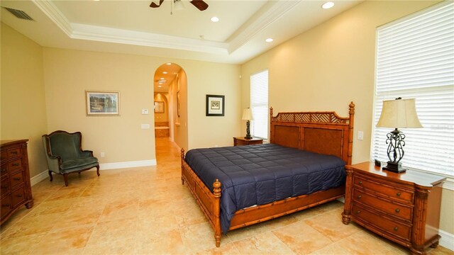 6057 Calusa Ridge Trl, Bokeelia, FL 33922 - bedroom featuring arched walkways, a raised ceiling, recessed lighting, a ceiling fan, and baseboards