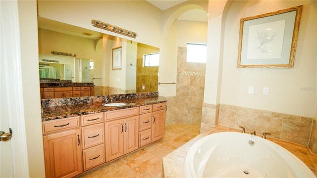 6057 Calusa Ridge Trl, Bokeelia, FL 33922 - bathroom with a tub with jets, vanity, and walk in shower