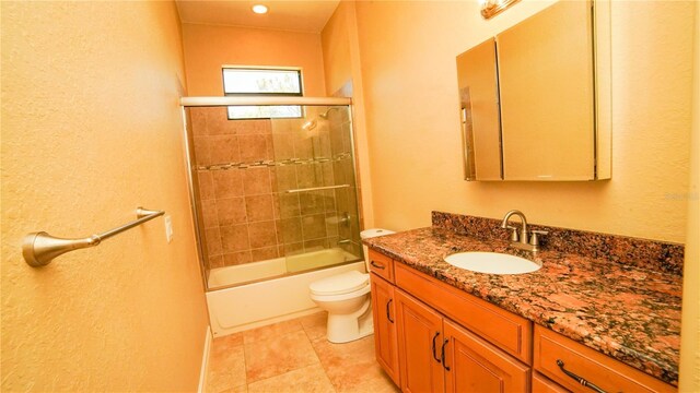 6057 Calusa Ridge Trl, Bokeelia, FL 33922 - full bath with vanity, toilet, bath / shower combo with glass door, and a textured wall
