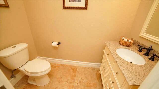 6057 Calusa Ridge Trl, Bokeelia, FL 33922 - half bathroom featuring baseboards, vanity, and toilet