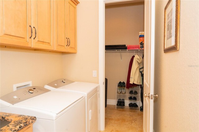6057 Calusa Ridge Trl, Bokeelia, FL 33922 - laundry area featuring cabinet space, washing machine and clothes dryer, light tile patterned floors, and baseboards