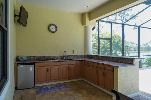 6057 Calusa Ridge Trl, Bokeelia, FL 33922 - kitchen with a sink, a textured wall, dishwasher, stainless steel gas cooktop, and plenty of natural light