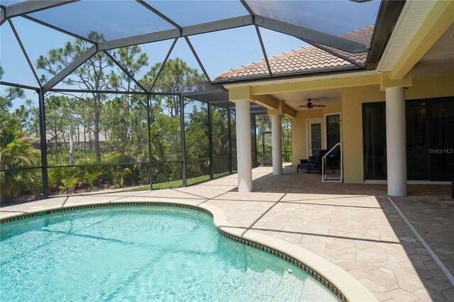 6057 Calusa Ridge Trl, Bokeelia, FL 33922 - outdoor pool with a patio area, ceiling fan, and glass enclosure