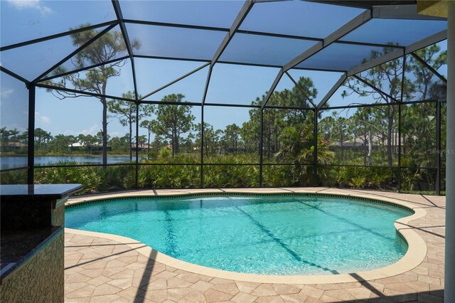 6057 Calusa Ridge Trl, Bokeelia, FL 33922 - swimming pool with a water view, a lanai, and a patio area